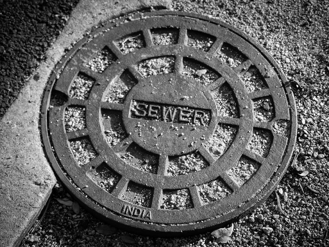 reed's black and white photo of a sewer cover